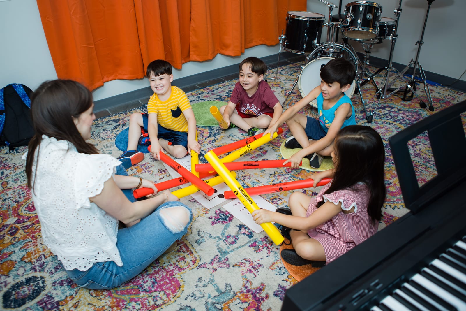 Twelve Tone Little Tones students engaged with boomwhackers at the Glenview studio — early music + cognition.
